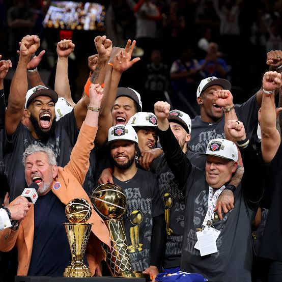 The New York Knicks celebrating the 2026 championship with the trophies