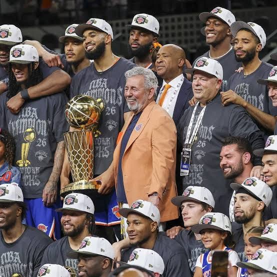 The 2026 champion Knicks team photo with the Larry O'Brien trophy